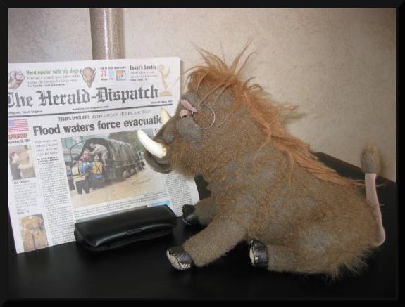 Me reading The Herald Dispatch headlines... .  (c) 2004 David Coyote 