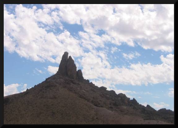 Desert Peek and Clouds (c) 2005 David Coyote